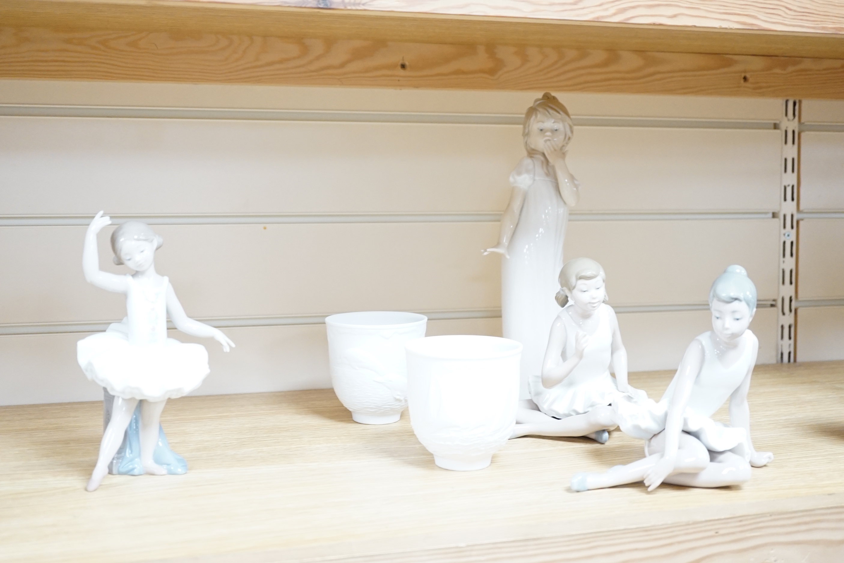 Twelve Lladro figures including a dog and three ducks, a plaque and two cups together ith three Nao figures, tallest figure 32cm high (original boxes included)